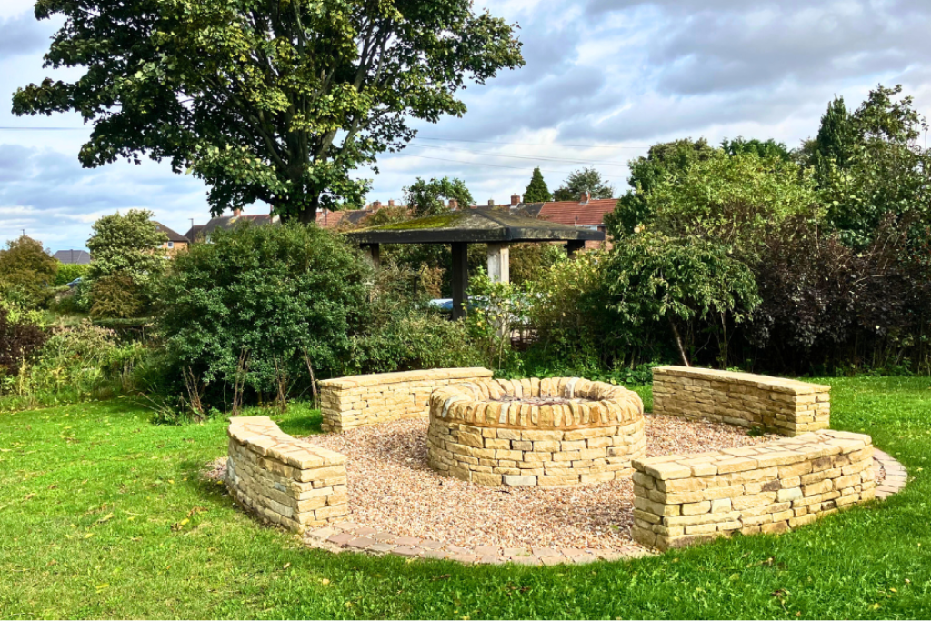 Stone fire pit in the private gardens outside Sheffield wedding venue Manor Oaks House.