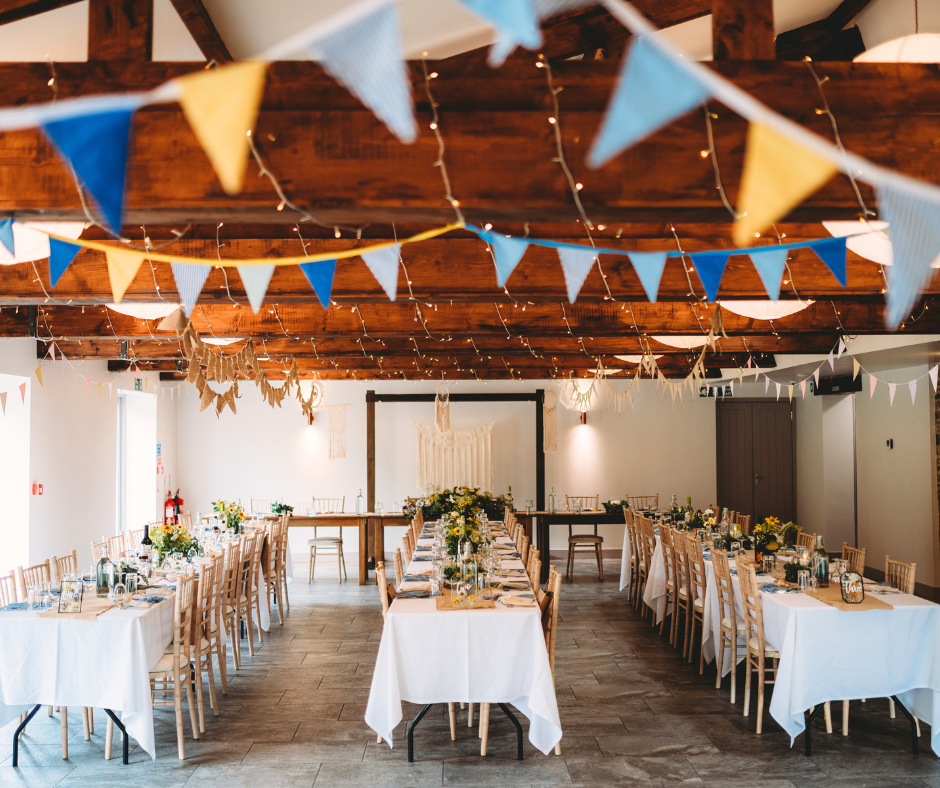 Party bunting hanging from the wooden beams inside Sheffield party venue Manor Oaks House.