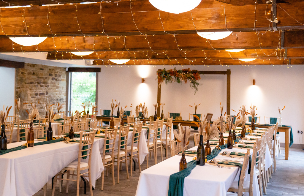 Tables set up for a wedding reception inside Sheffield venue Manor Oaks House.
